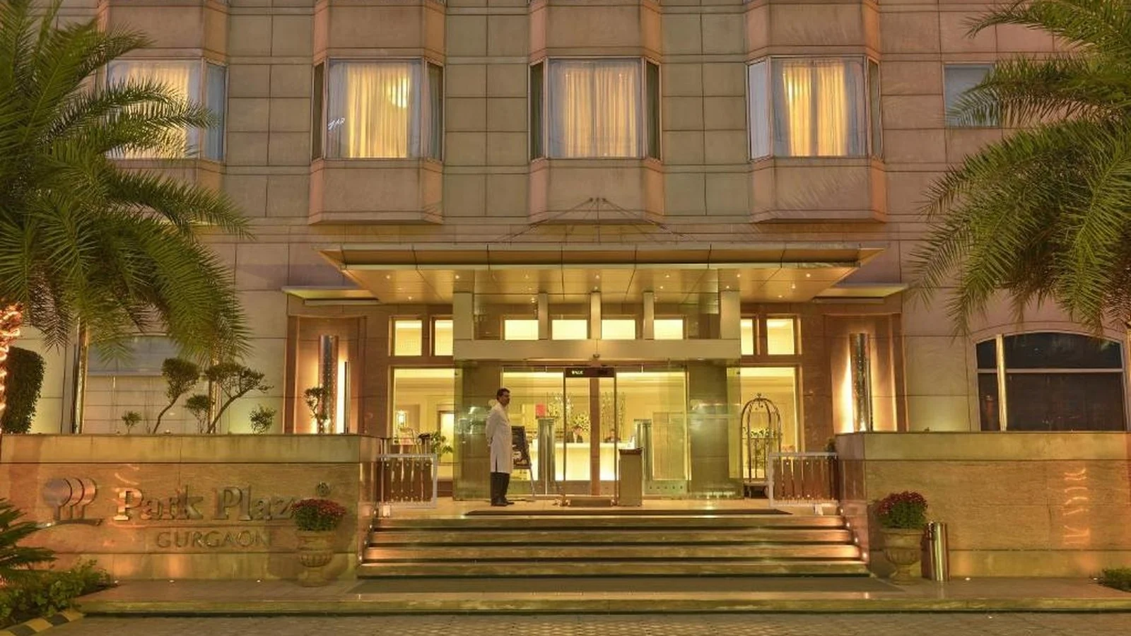 Exterior entrance and facade of Park Plaza Gurgaon hotel in Gurugram with valet drop-off area.