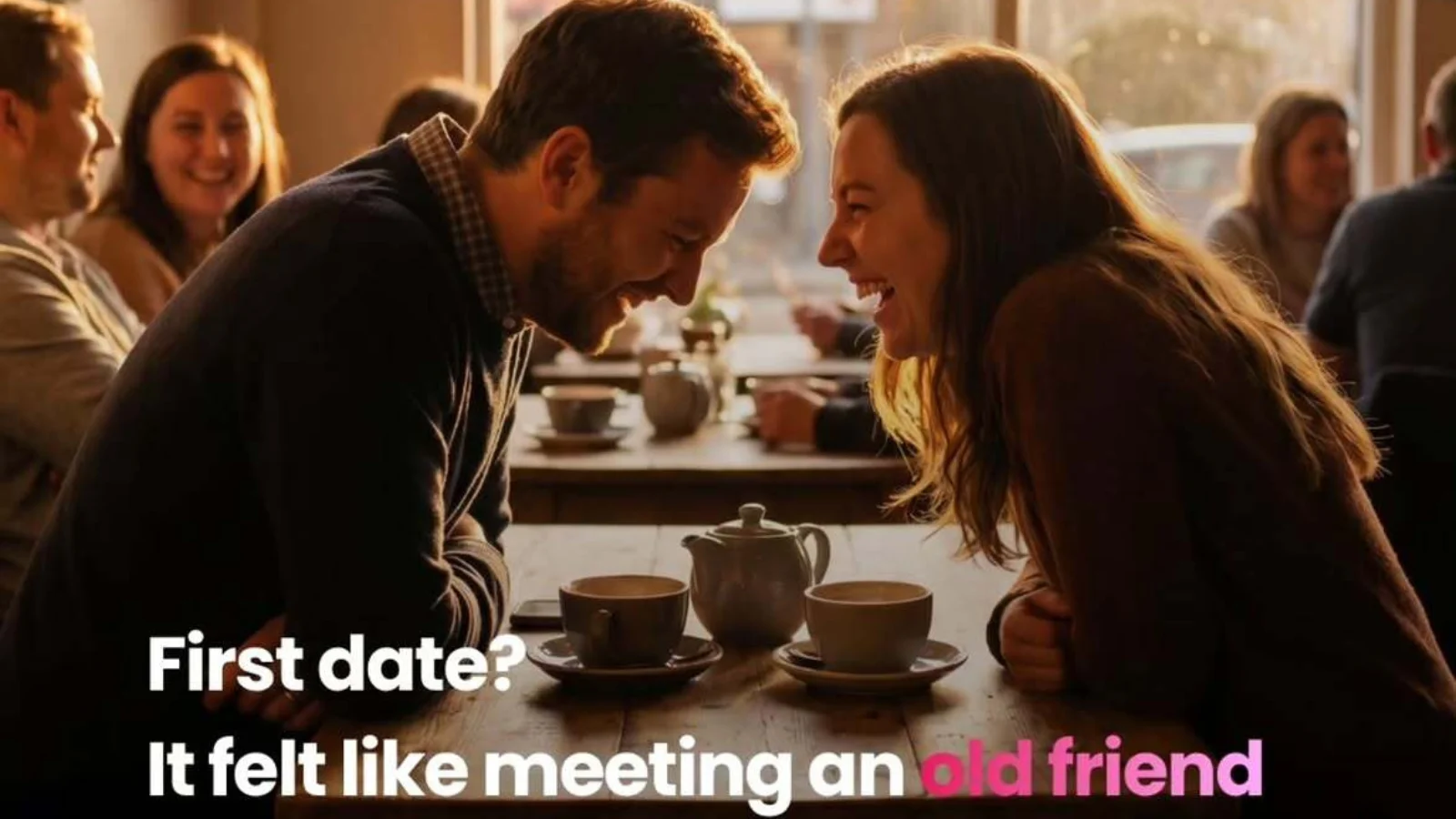 Happy couple smiling and leaning toward each other at a cafe table on a first date.